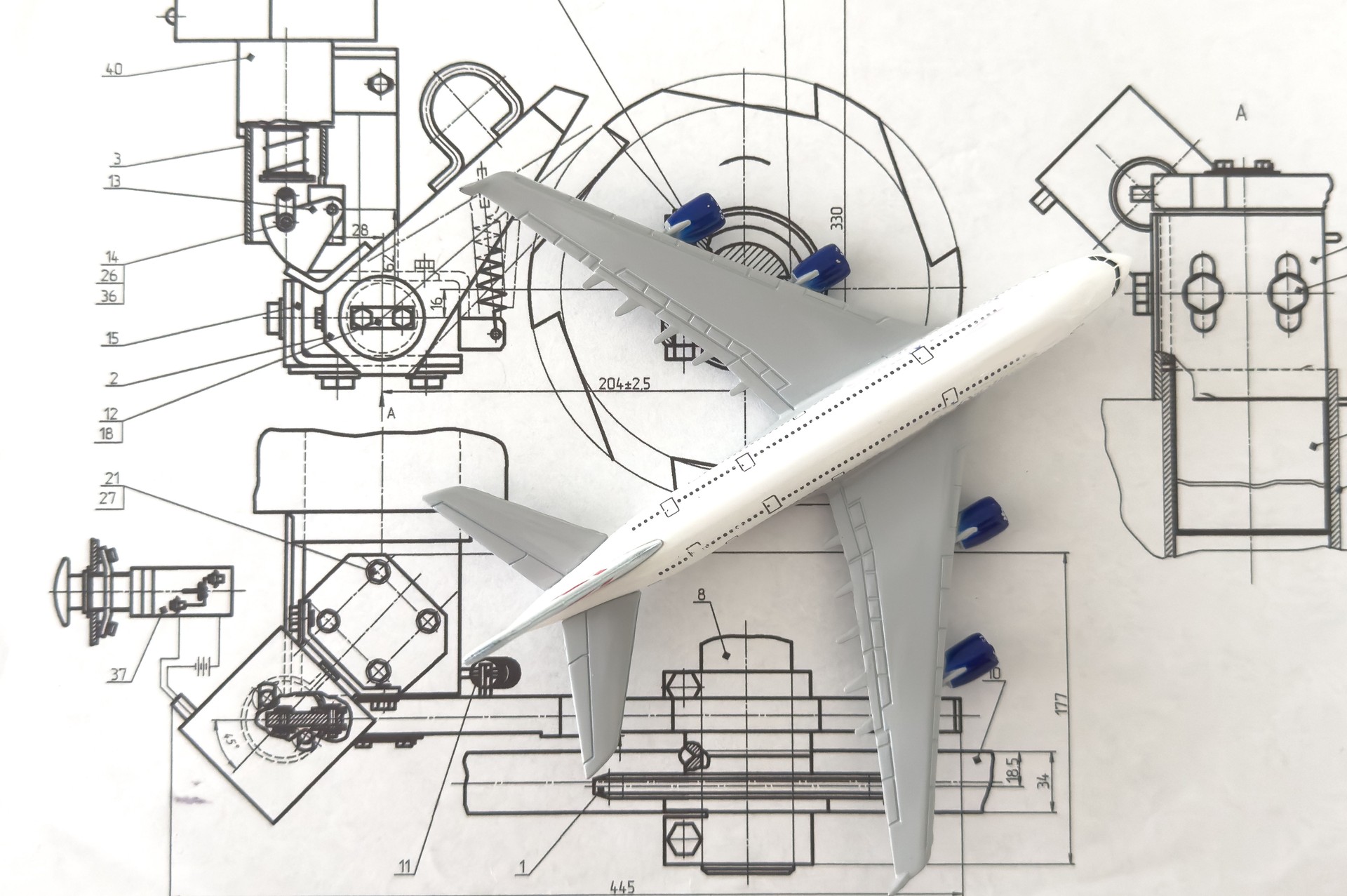 Image of passenger airplane and engineering blueprint